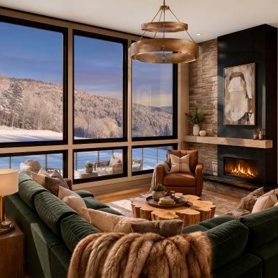 Cozy modern living room with a fireplace and snowy mountain views.